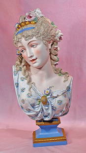 GRAND FRENCH BISQUE BUST OF ELEGANT LADY WITH ELABORATELY-SCULPTED HAIR: GRAND FRENCH BISQUE BUST OF ELEGANT LADY WITH ELABORATELY-SCULPTED HAIR. 22”. Marks: Signed on the back in large letter “Paul Duboy”. Bisque bust depicting an elegant woman posed with he