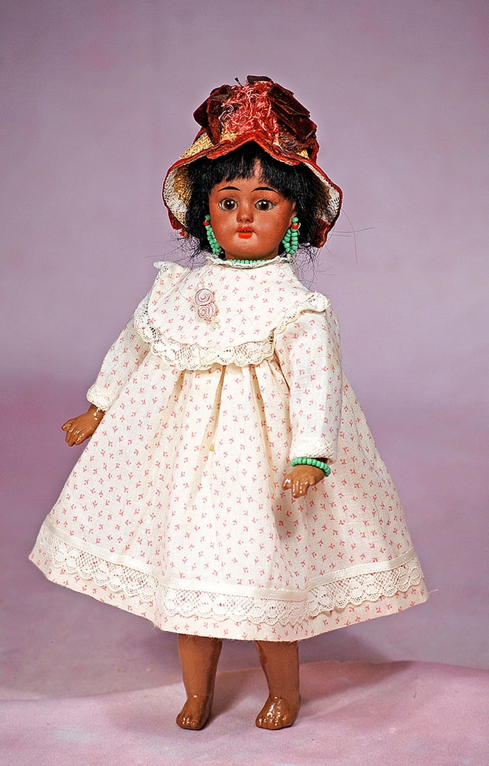 PETITE GERMAN BISQUE BROWN-COMPLEXIONED DOLL BY SIMON AND HALBIG: PETITE GERMAN BISQUE BROWN-COMPLEXIONED DOLL BY SIMON AND HALBIG. 9 ½”. Marks: 1078 Halbig S & H. Brown bisque socket head, brown sleep eyes, painted lashes, tapered brows, open mouth, uppe