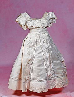 WHITE PIQUE FASHION GOWN: WHITE PIQUE FASHION GOWN. White cotton pique gown features a square cut low neckline, fitted bodice, flat front skirt which extends into box pleats at the back, decorated with elaborate detail compris