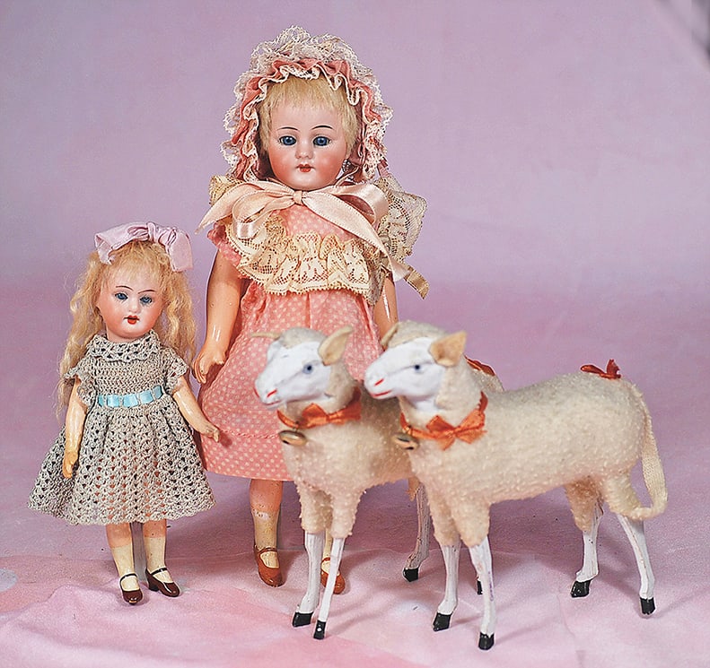 TWO PETITE GERMAN BISQUE DOLLS: TWO PETITE GERMAN BISQUE DOLLS. Each is bisque socket head with blue sleep eyes, painted lashes, tapered brows, open mouth, upper teeth, blonde mohair wig, five-piece jointed composition flapper-type