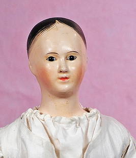 FRENCH PAPER MACHE LADY WITH GLASS EYES: FRENCH PAPER MACHE LADY WITH GLASS EYES. 20”. Paper mache shoulderhead, painted black hair, fully-modeled ears, inset dark glass eyes, painted lashes, tapered brows, closed mouth, slender