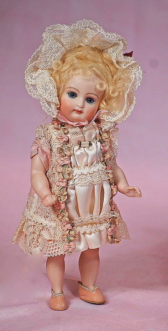 LITTLE ALL-BISQUE DOLL BY DARLENE LANE: LITTLE ALL-BISQUE DOLL BY DARLENE LANE. 7”. Marks: Darlene Lane 2000. Bisque swivel head on five-piece jointed bisque body, stationary blue glass eyes, painted lashes, closed mouth, blonde mohai