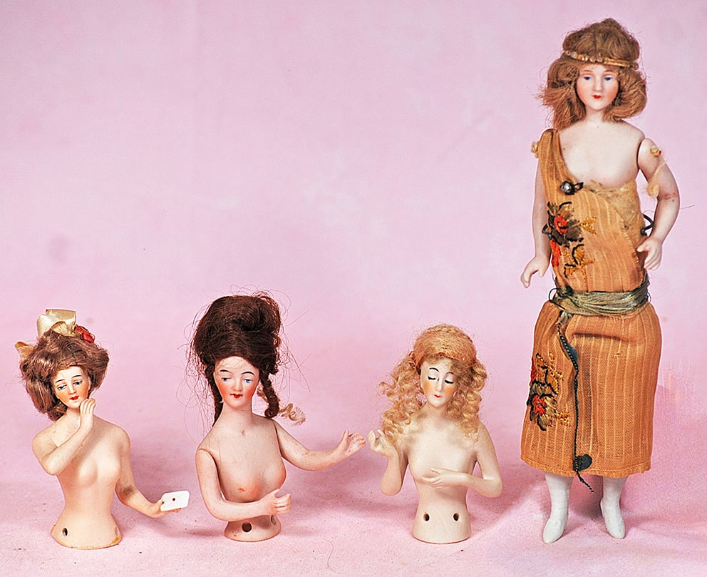 THREE GERMAN BISQUE HALF DOLLS AND HALF DOLL FLAPPER: THREE GERMAN BISQUE HALF DOLLS AND HALF DOLL FLAPPER. Flapper is 7 ½” with jointed shoulders, painted features, mohair wig, cloth body bisque lower limbs, original dress; Half dolls are 3&#