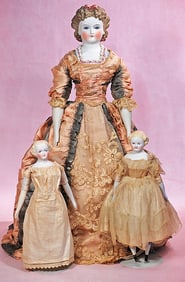 GERMAN BISQUE LADY WITH GLASS EYES AND SCULPTED HAIR PLUS TWO SMALL BISQUE LADY DOLLS