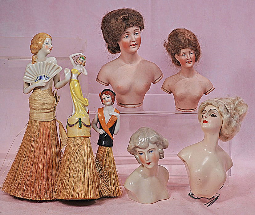 FOUR HALF DOLLS AND THREE HAT BRUSH HALF DOLLS: FOUR HALF DOLLS AND THREE HAT BRUSH HALF DOLLS. 4 ½” and 5” German bisque half dolls with painted features and original wigs; 4” porcelain half doll bust; 5” wax half doll