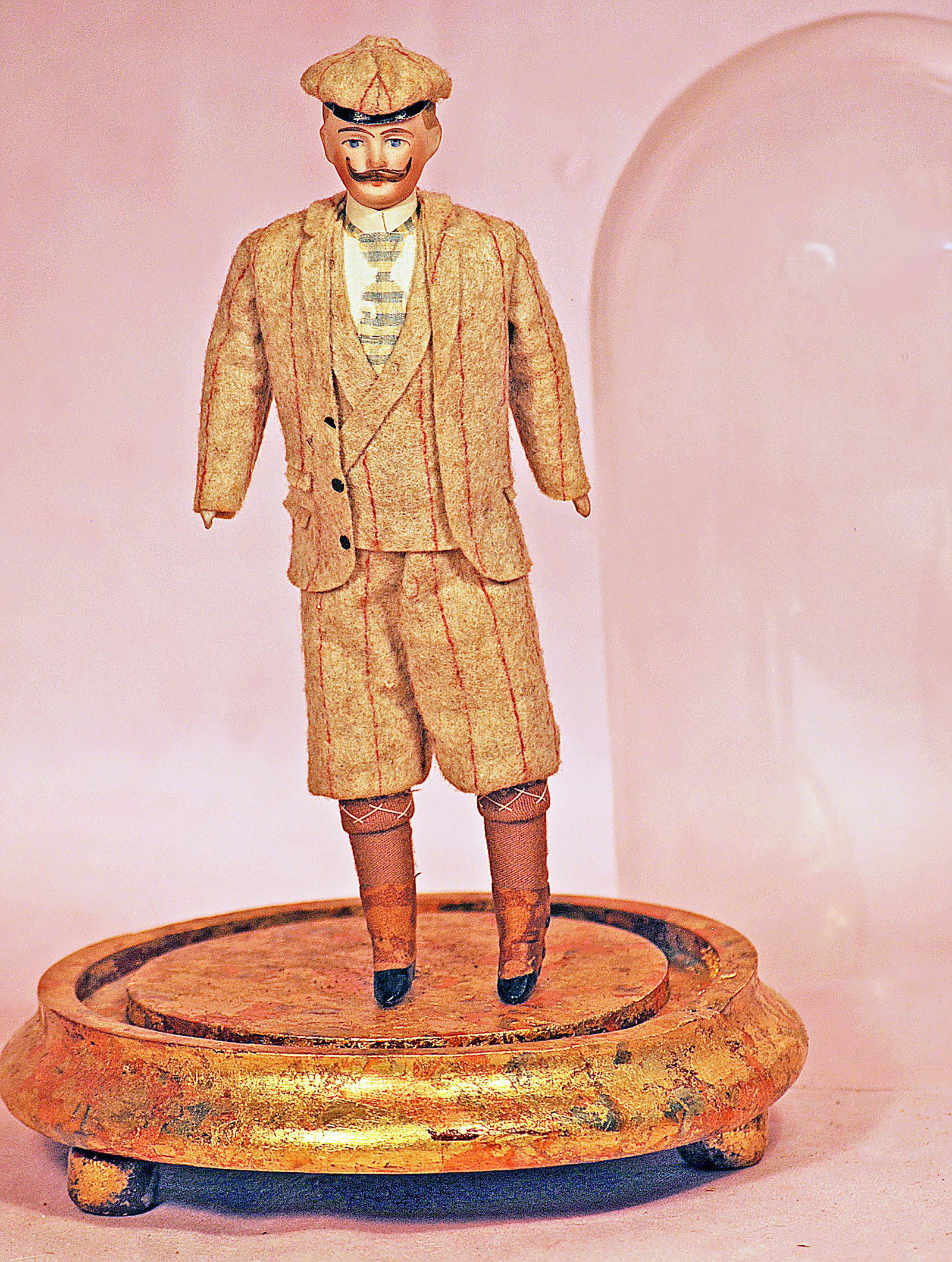 GERMAN BISQUE DOLLHOUSE GENTLEMAN IN ORIGINAL COSTUME.: 7. GERMAN BISQUE DOLLHOUSE GENTLEMAN IN ORIGINAL COSTUME. 7”. Bisque shoulderhead with sculpted hair and mustache, painted features, cloth body, bisque lower limbs, all-original costume, with gl