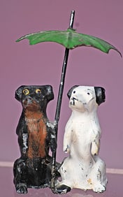 MINIATURE LEAD DOGS UNDER GREEN UMBRELLA.