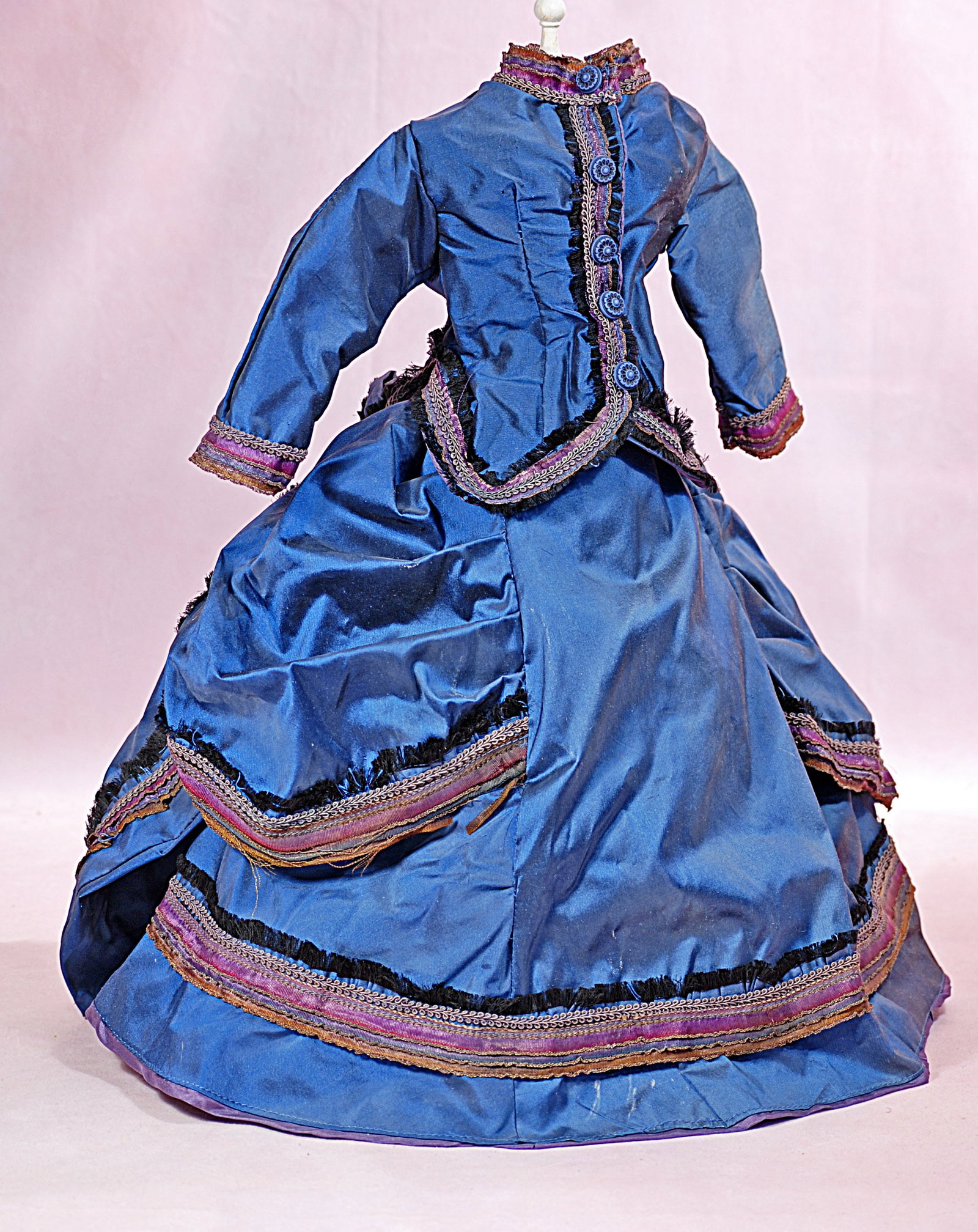 BLUE SILK FASHION GOWN.: 50. BLUE SILK FASHION GOWN. Blue silk taffeta gown comprising a fitted jacket with long sleeves, banded collar, front button closing, flat-front skirt with pleated and poufed side panels plus gathered