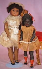TWO BROWN COMPLEXIONED BISQUE DOLLS