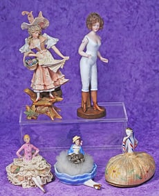 GROUP OF PORCELAIN AND BISQUE HALF DOLLS AND FIGURINES