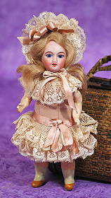 MINIATURE FRENCH BISQUE BEBE BY UNIS.: MINIATURE FRENCH BISQUE BEBE BY UNIS. 6 Β½β. Marks: Unis France. Bisque socket head, stationary blue glass inset eyes, painted lashes, tapered brows, open mouth, shaded lips, upper teeth, bl