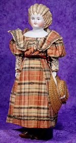 GERMAN PORCELAIN LADY WITH BROWN SPILL CURLS.