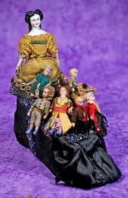 GERMAN PORCELAIN LADY WITH MINIATURE DOLLS AS OLD WOMAN WHO LIVED IN A SHOE. 8 ½” l. x 7