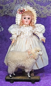 FLEECY LAMB PULL TOY ON WOODEN PLATFORM.