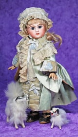 PETITE FRENCH BISQUE FIGURE A BEBE BY JULES STEINER WITH SALON DOGS.