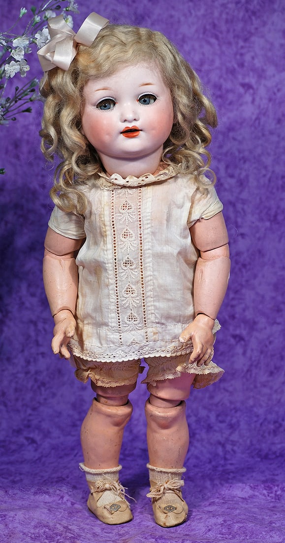 GERMAN BISQUE CHARACTER, 985, BY MARSEILLE WITH TODDLER BODY AND ORIGINAL WIG.: GERMAN BISQUE CHARACTER, 985, BY MARSEILLE WITH TODDLER BODY AND ORIGINAL WIG. 17”. Marks: Germany 985 A 6/0 M. Bisque socket head, plump rounded face with deep cheek dimples, blue sleep eyes, p