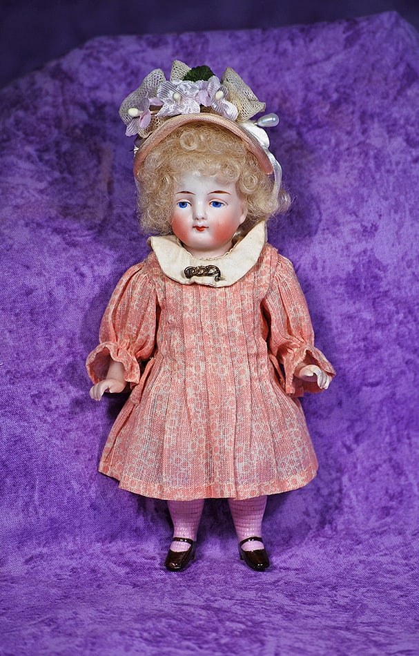 GERMAN ALL-BISQUE DOLL WITH PINK STOCKINGS.: GERMAN ALL-BISQUE DOLL WITH PINK STOCKINGS. 5”. All-bisque, solid dome with painted features, blue eyes, upper eyeliner, tapered brows, closed mouth, jointed at shoulders, painted pink knee stoc