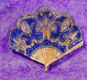 TWELVE BLADE FOLDING FAN WITH GILT DECORATIONS.