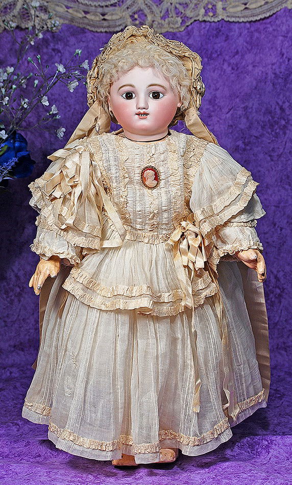 RARE EARLY BISQUE CHILD BY JULES STEINER.: RARE EARLY BISQUE CHILD BY JULES STEINER. 21”. Marks: Solid domed bisque head with flat-cut neck socket, blue glass inset eyes, dark eyeliner, painted lashes, feathered brows, open mouth with ou
