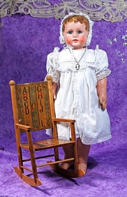 ALABAMA BABY DOLL WITH BROWN CURLY HAIR.