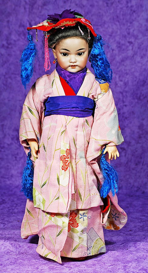 GERMAN BISQUE ASIAN PORTRAIT DOLL, 1199, BY SIMON AND HALBIG.: GERMAN BISQUE ASIAN PORTRAIT DOLL, 1199, BY SIMON AND HALBIG. 15”. Marks: S & H 1199 Dep Germany 6. Bisque socket head with amber tinted complexion and deeply-sculpted features, almond-shaped br