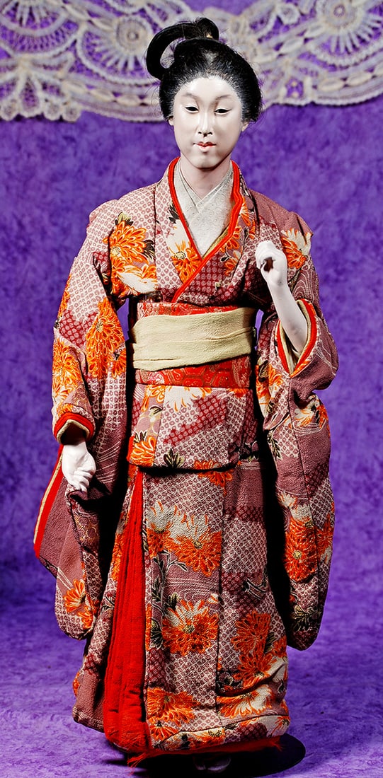 JAPANESE LADY WITH EXTRAORDINARY COIFFURE.: JAPANESE LADY WITH EXTRAORDINARY COIFFURE. 24”. Gofun-finished head with very expressive, dark enamel eyes, closed mouth, black silk hair in elaborate coiffure, wearing original colorful flowere