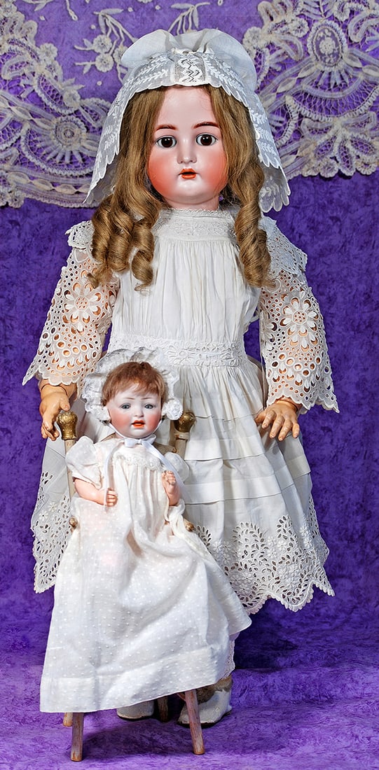 SMALL GERMAN BISQUE BABY BY HERTEL AND SCHWAB WITH HIGH CHAIR.: SMALL GERMAN BISQUE BABY BY HERTEL AND SCHWAB WITH HIGH CHAIR. 9 ½”. Marks: 152 made in Germany. Bisque socket head, blue sleep eyes, painted lashes, feathered brows, open mouth, accented l