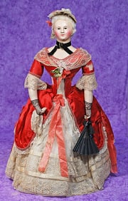 FRENCH PAPER MACHE POUPEE WITH GLASS EYES AND ORIGINAL COSTUME.