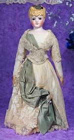 GERMAN BISQUE LADY WITH SCULPTED HAIR AND GLASS EYES.