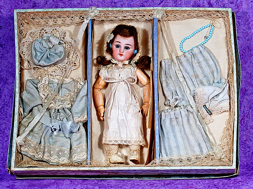 FRENCH BISQUE DEP BEBE IN ORIGINAL PRESENTATION BOX.: FRENCH BISQUE DEP BEBE IN ORIGINAL PRESENTATION BOX. 9” (doll) incised DEP, Jumeau red stamp. A bisque-headed doll with blue sleep eyes, painted lower lashes, feathered brow, open mouth, teeth,