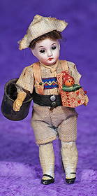 MINIATURE GERMAN BISQUE DOLL.: MINIATURE GERMAN BISQUE DOLL. 5β. 39 over 13. Bisque socket head, stationary brown glass eyes, painted lashes and brows, closed mouth, mohair wig, five-piece paper mache body, painted shoes and