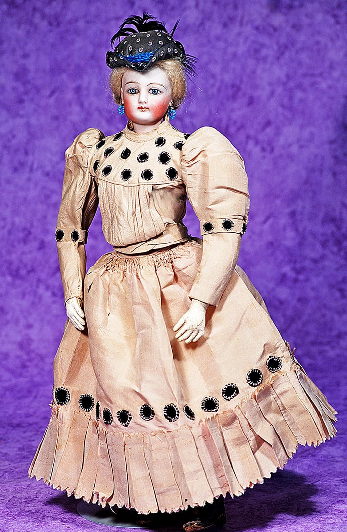 PETITE FRENCH BISQUE POUPEE.: PETITE FRENCH BISQUE POUPEE. 14”. Marks: 1. Bisque swivel head on bisque shoulderplate, almond-shaped blue paperweight eyes, painted lashes, dark eyeliner, multi-stroked brows, pierced ears, clo