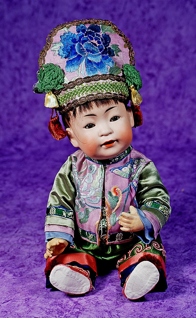 GERMAN BISQUE CHINESE BABY, 243, BY KESTNER.: GERMAN BISQUE CHINESE BABY, 243, BY KESTNER. 15”. Marks: made in Germany JDK 243. Amber-tinted bisque socket head, brown sleep eyes, dark eyeliner, painted lashes, black feathered brows, open mo