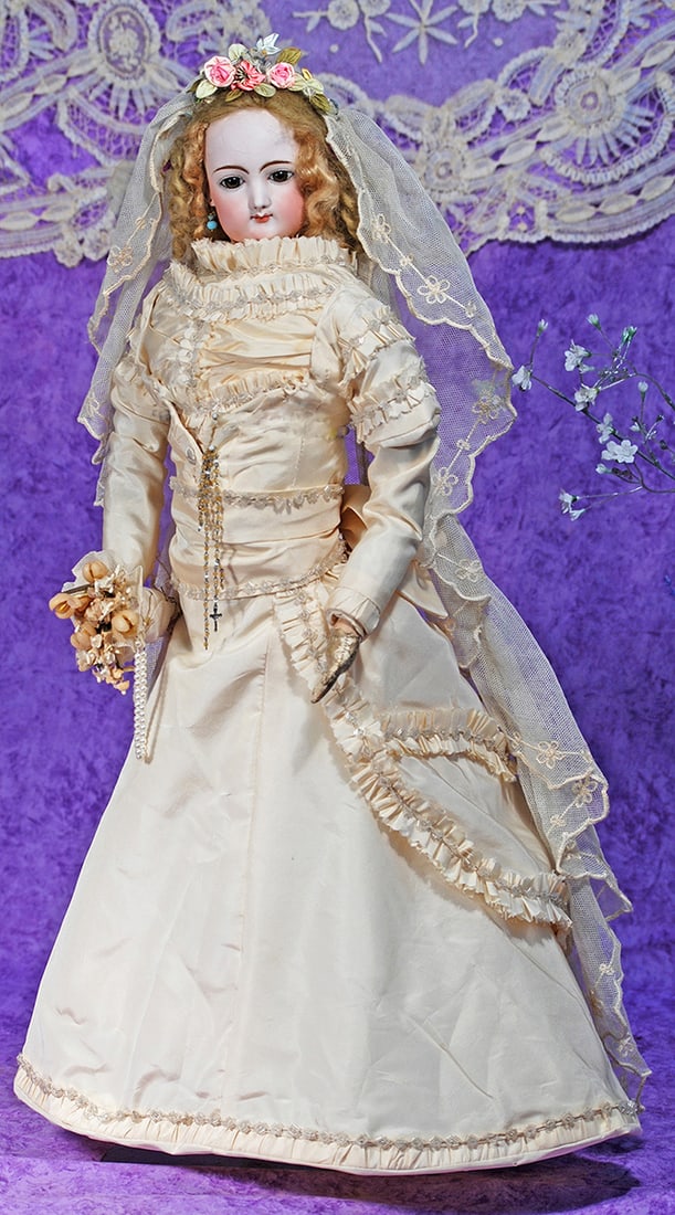 FRENCH BISQUE POUPEE IN BRIDAL GOWN BY GAULTHIER.: FRENCH BISQUE POUPEE IN BRIDAL GOWN BY GAULTHIER. 22”. Marks: 6. Bisque swivel head on bisque shoulderplate, blue paperweight eyes, painted lashes, dark eyeliner, feathered brows, pierced ears,