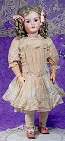GERMAN BISQUE DOLL BY SIMON AND HALBIG WITH FACTORY ORIGINAL DRESS AND WIG.