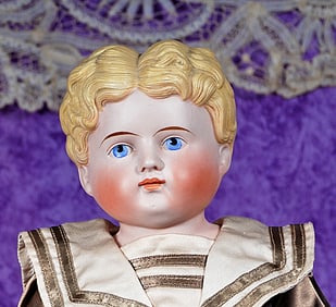 GERMAN BISQUE DOLL WITH SCULPTED BLONDE HAIR..