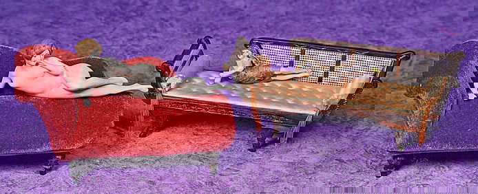 TWO GERMAN BISQUE BATHING BEAUTIES ON CHAISE LOUNGES.