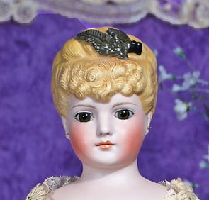 GERMAN BISQUE LADY WITH SCULPTED HAIR  AND GLASS EYES.