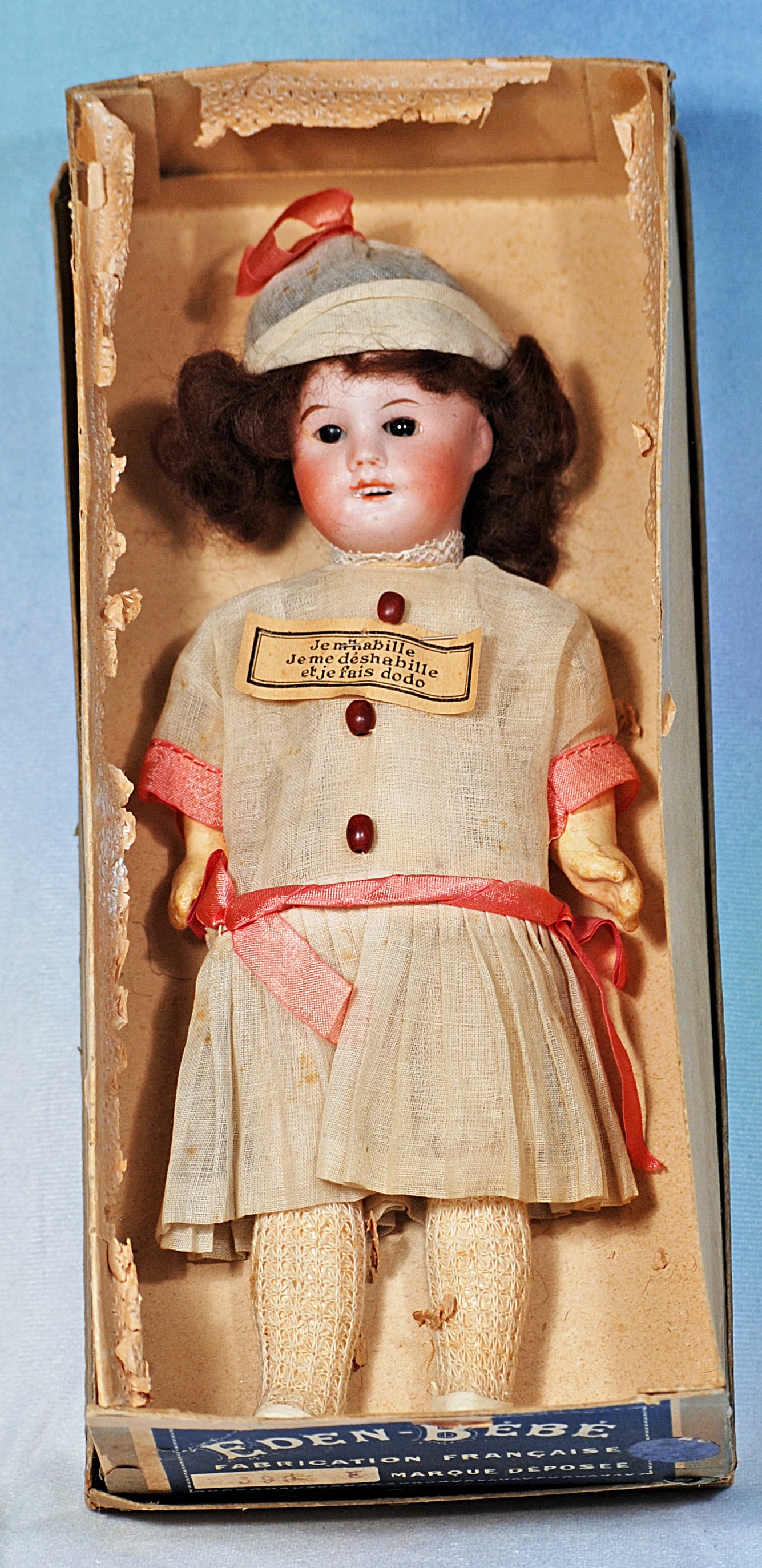PETITE FRENCH BISQUE S.F.B.J., EDEN BEBE, IN ORIGINAL BOX.: 40. PETITE FRENCH BISQUE S.F.B.J., EDEN BEBE, IN ORIGINAL BOX. 9”. Marks: SFBJ 60 Paris. Bisque socket head, brown sleep eyes, tapered brows, open mouth, upper teeth, brunette mohair wig, five-p