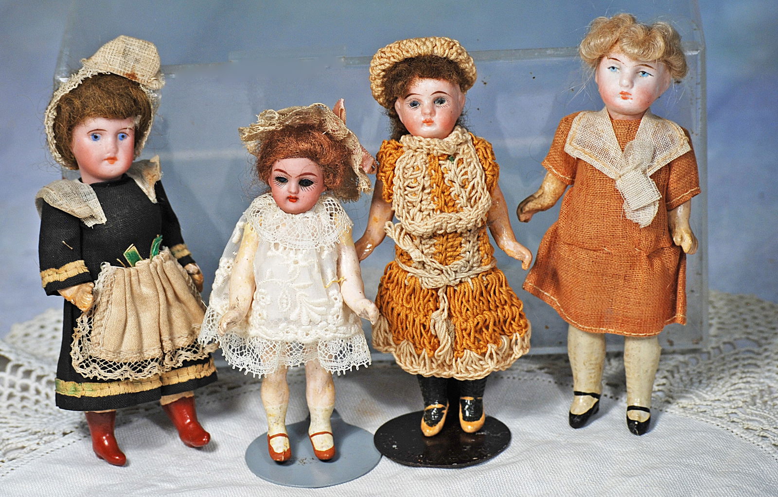 FOUR MINIATURE BISQUE DOLLS. (1 of 1)