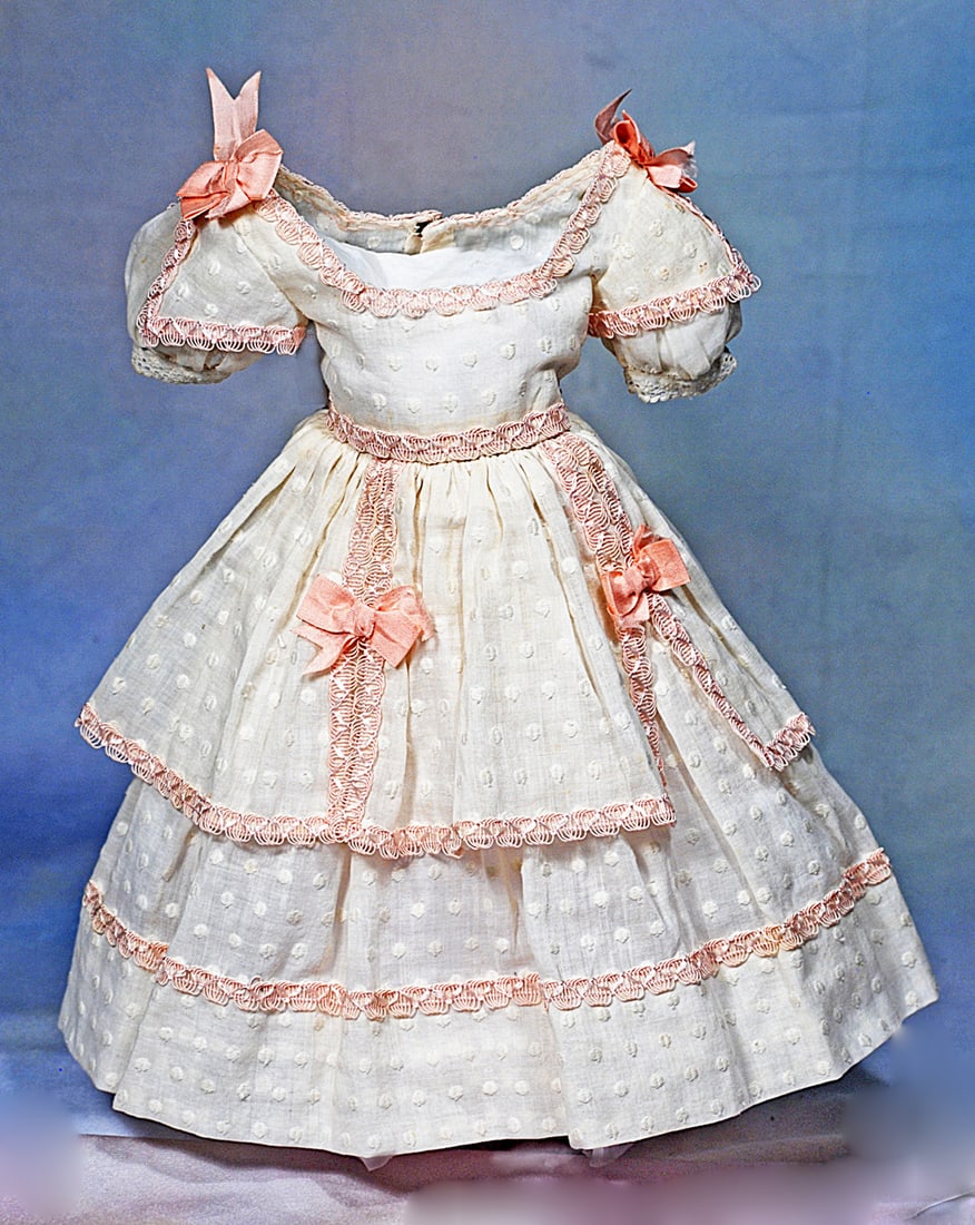 WHITE DOTTED SWISS DRESS WITH PINK TRIM:  Dainty white dotted swiss dress features a fitted bodice with low rounded neckline, short puffed sleeves, gathered skirt with short, three-panel overskirt, back hook-eye closure, sized for 17