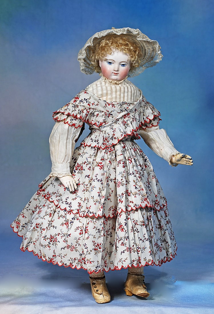 FRENCH BISQUE POUPEE BY ADELAIDE HURET KNOWN AS "CHIFFONNETTE”: Bisque socket head with very full plump cheeks and bulbous shape of throat, painted blue downward glancing eyes with darker blue pupil rims, thick black eyeliner, feathered brows, closed mouth with da