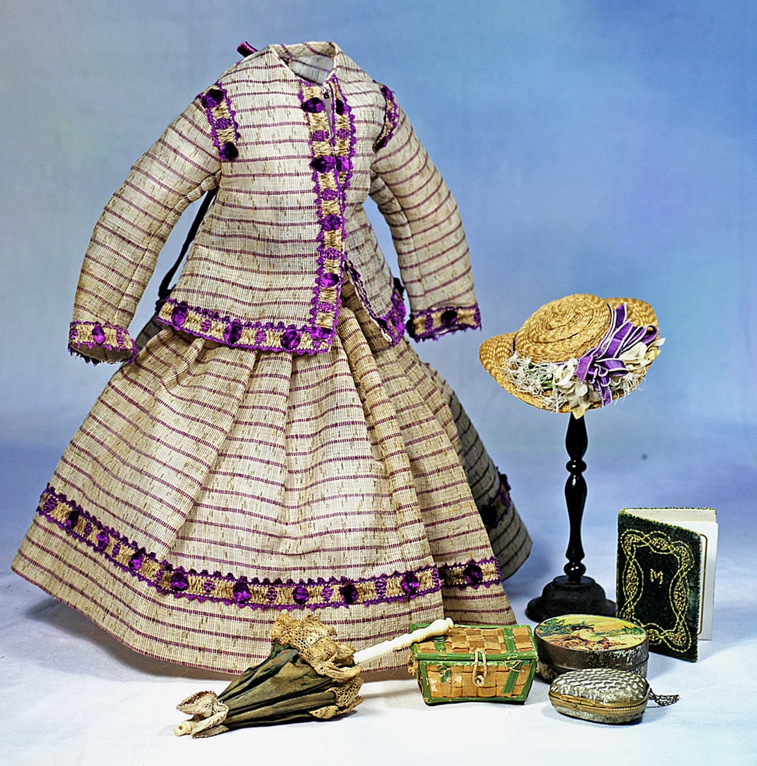 LOVELY SILK AND WOOL ENSEMBLE FOR POUPEE: an silky wool fabric with horizontal bands of magenta made up in a flared, long sleeve jacket and pleated full skirt with decorative waistband, trimmed all around with magenta silk bands having tufts