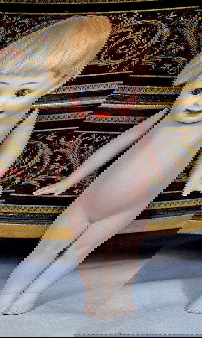 GERMAN ALL-BISQUE “OUR FAIRY”: 5 1/2”. Marks: 222-14. One piece bisque head, torso and legs, chubby face, blue side-glancing googly eyes, painted lashes, feathered brows, closed mouth with impish smile, blonde mohair