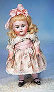 LARGE MODEL OF KESTNER ALL-BISQUE DOLL: 11”. Marks: 150 / 6. All-bisque, jointed at shoulders and hips, brown sleep eyes, painted lashes, feathered brows, open mouth, accented lips, upper teeth, blonde mohair wig, painted