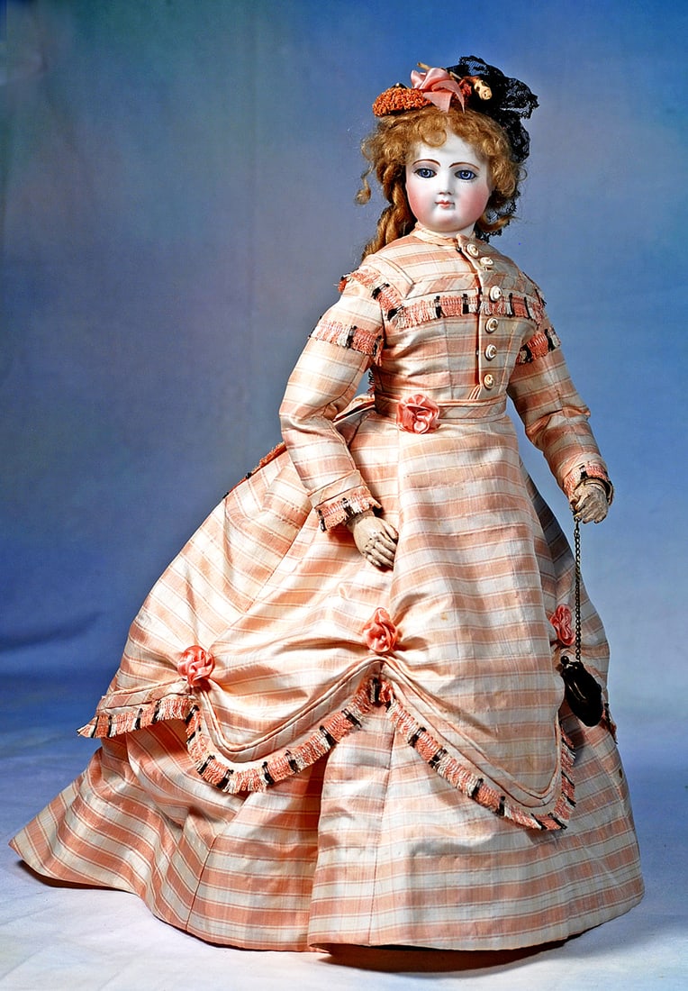 FRENCH BISQUE POUPEE WITH ARTICULATED WOODEN BODY ATTRIBUTED TO JUMEAU. (1 of 2)