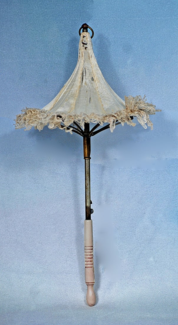 RARE FRENCH PAGODA STYLE SILK PARASOL: 8 ½”. White silk parasol with lace edging, fitted with rare curved tines which create a pagoda type shape, metal tip, bone handle.