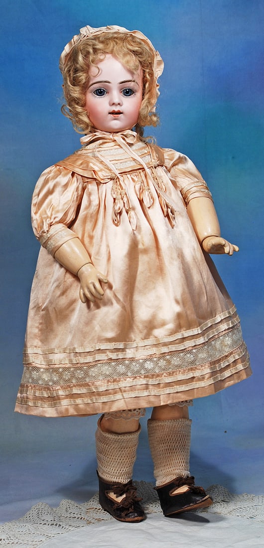 FRENCH BISQUE, SIZE 9, BRU JNE R. BEBE: 22”. Marks: Bru Jne R 9. Bisque socket head, blue paperweight eyes, painted lashes, eyeliner, feathered and widely-arched brows, pierced ears, open mouth, shaded and accented lips,