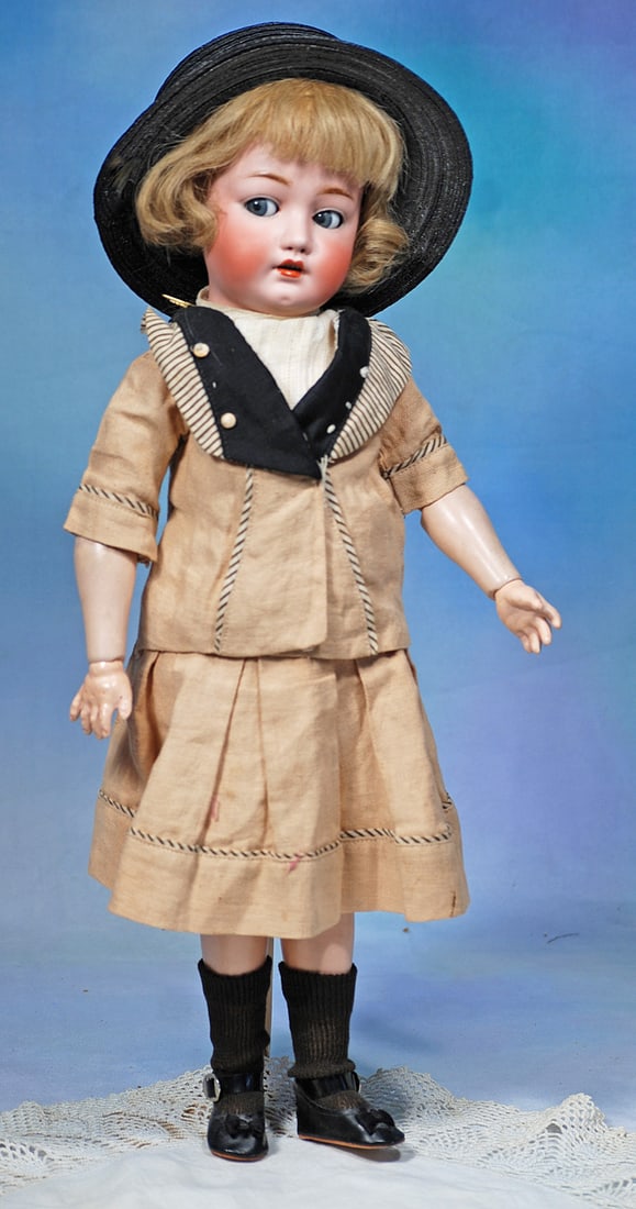 GERMAN BISQUE FLIRTY-EYED DOLL, 269, BY FRANZ SCHMIDT: 19”. Marks: 269 S & C. Bisque socket head, blue sleep and flirty eyes, painted lashes, eyeliner, feathered brows, open mouth, accented lips, upper teeth, original blonde human hair wig,