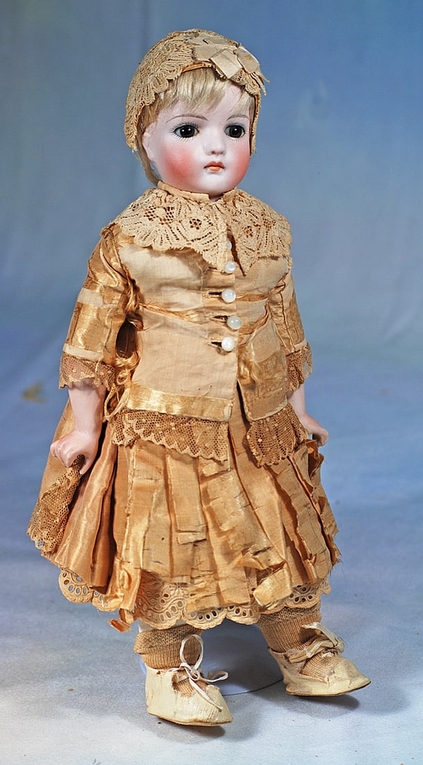 GERMAN BISQUE CLOSED-MOUTH DOLL BY KLING: 11”. Marks: 121 - 3. Bisque solid-dome shoulderhead, inst brown glass eyes, painted lashes, eyeliner, feathered brows, closed mouth, accented lips, original blonde mohair wig,